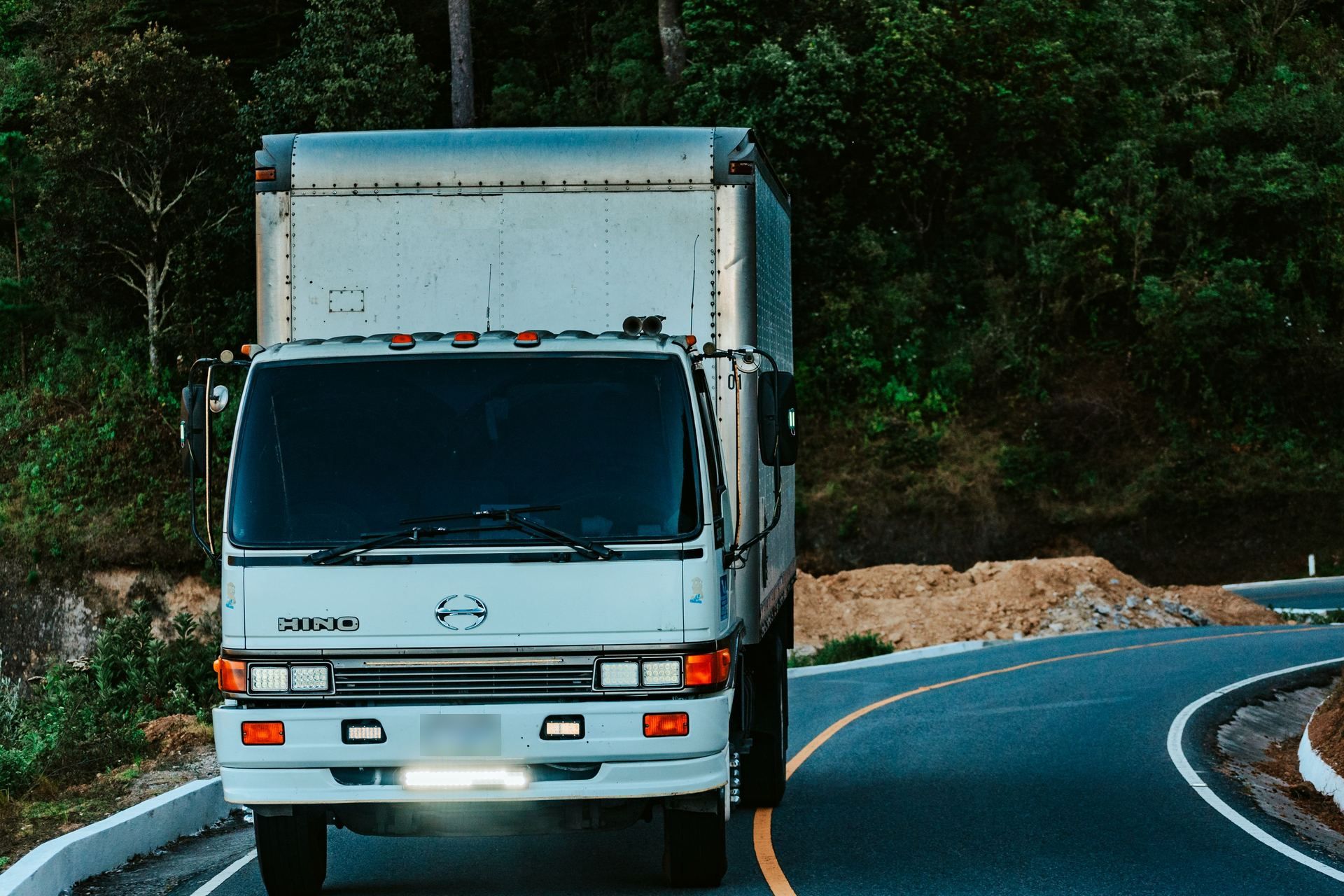 White box truck on a winding road